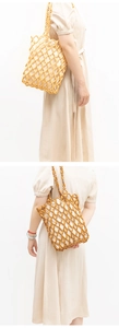 Detail of handmade wooden bead bags in light and dark brown with drawstring lining