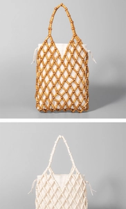 Close-up of handmade woven wooden bead handbag with drawstring inner linen pouch