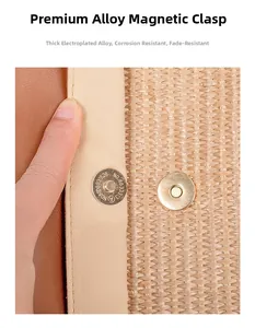 Detail of durable alloy magnetic clasp on a woven straw beach bag with leather trim