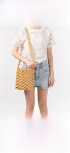 Detail of a handmade wooden bead crossbody bag featuring rustic natural wood textures