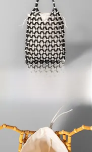 Detail view of handmade beaded bag featuring wooden beads and canvas drawstring inner pouch
