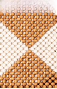 Macro shot of polished bicolored wooden beads in a geometric woven pattern on the handbag