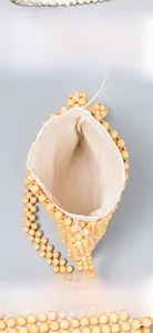Detail view of woven beaded bag interior showing the inner lining and daily essentials