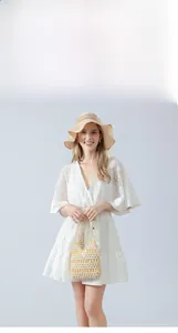 Detail of handcrafted maple wood beaded tote bag in cream white for summer resort wear