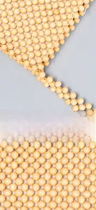 Detail of hand-woven crossbody bag showing polished light yellow wooden beads craftsmanship