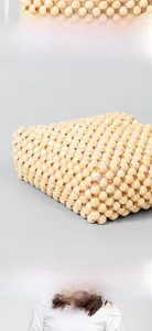 Detail of handcrafted wooden bead handbag showing natural wood grain and woven structure