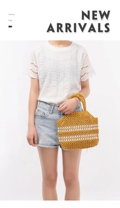 Close-up of handmade yellow and white beaded trapezoid handbag with woven top handle