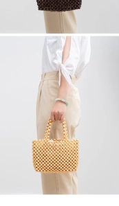 Detailed macro of handmade wooden bead handbag showing natural wood texture and craftsmanship