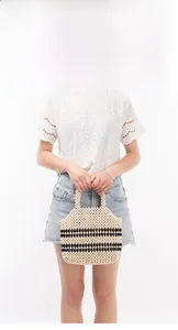 Detailed shot of handmade woven wood bead handbag with black and white stripes