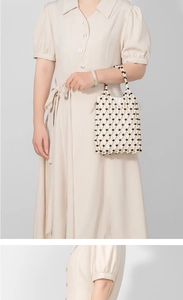 Detail of handmade beaded handbag with ivory tubes, black beads and drawstring liner