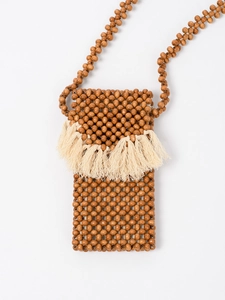 Handmade wooden bead crossbody bag with cream cotton tassels and woven strap details