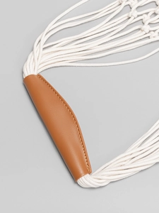 Handwoven cotton net beach bag with premium brown leather handle detail and minimal design