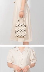 Detailed view of handmade woven bag with white beads, black accents and fabric lining