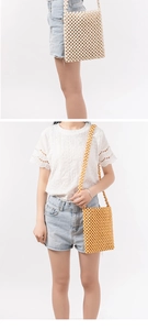 Detail of handmade beaded crossbody bags in cream and ginger yellow with wooden beads