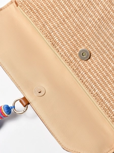Handwoven straw beach bag with fabric lining, metal magnetic closure and colorful tassel