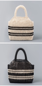 Macro detail of handmade beaded tote bags with black and white woven striped patterns