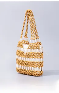 Detail of handcrafted woven maple beads and white canvas drawstring liner bag
