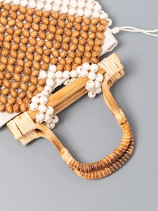 Handcrafted wood bead handbag with contrast colors and natural bamboo handle for beach vacations