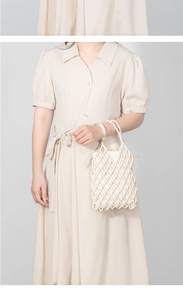 Detail of handmade cream beaded handbag with intricate hollow mesh weaving and top handle