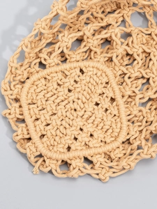 Detailed macro view of beige cotton woven beach bag showing intricate knotting and net texture