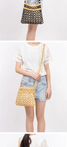 Detail of hand-woven beaded crossbody bag with wooden beads in yellow and black colors