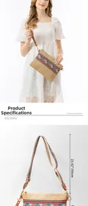 Detail view showing woven straw bag strap length measurement with premium hardware details