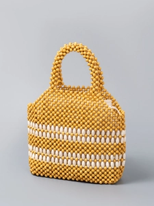 Handmade woven beaded handbag for women featuring yellow and white beads with a top handle