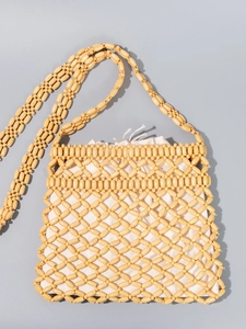 Handmade woven crossbody bag with yellow wood beads and a cream drawstring liner