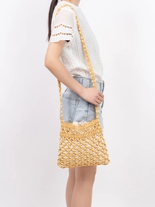 Handmade yellow wooden bead crossbody bag with woven mesh design and drawstring liner