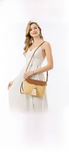 Straw crossbody bag with brown leather flap and tassel detail for beach vacations