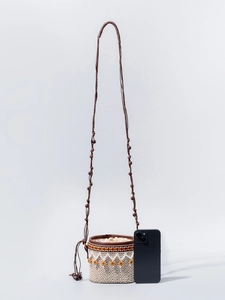 Miniature raffia bucket bag with geometric patterns and wooden beads for beach vacations