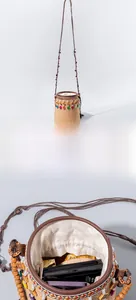Detail of straw bucket bag with colorful tassels, beaded trim and drawstring lining