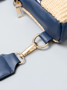 Blue leather and woven straw crossbody bag with elegant gold-tone metal hardware details