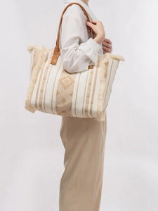 Ethnic style woven canvas tote bag with brown geometric patterns and fringe edges