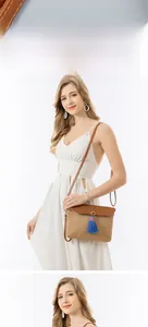 Detail of straw woven bag featuring a brown leather flap and vibrant blue tassels