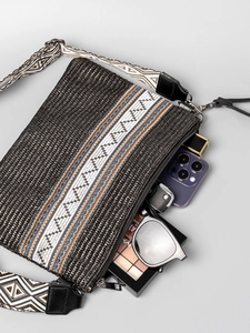 Black woven straw crossbody bag with ethnic embroidery and patterned wide shoulder strap