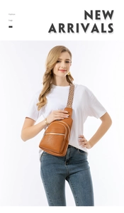 Close-up of brown pebbled leather sling bag with geometric woven strap and silver zippers
