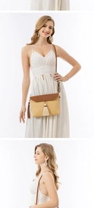 Detail of straw woven envelope bag with brown leather flap and stylish beige fringe tassel