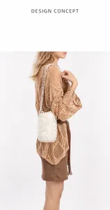 Detailed side view of a white woven pearl bucket bag with a transparent chain strap