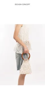 Detailed view of the woven pearl handbag featuring a round dark brown wooden handle