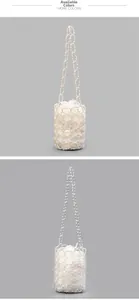 Detail of handmade beaded bucket bags in pearl white and clear finishes with mesh texture