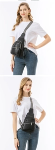 Detail of black pebbled PU leather crossbody bag with geometric ethnic patterned wide strap