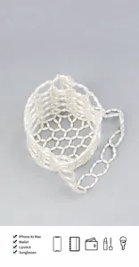 Detail view of pearl beaded bucket bag showing capacity for phone, wallet and cosmetics