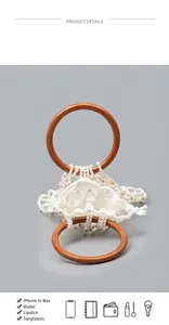Detail view of woven pearl handbag with resin handles showing large storage capacity