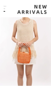 Detailed view of handmade bright orange beaded tote bag with woven handles and inner lining