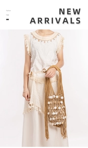 Detail of bohemian woven tote bag featuring white shell discs and long hanging tassels