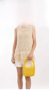 Detail of yellow handmade beaded hollow handbag for summer beach vacation style