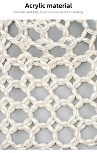 Close-up of handmade white acrylic beaded pattern on a stylish woven shoulder bag