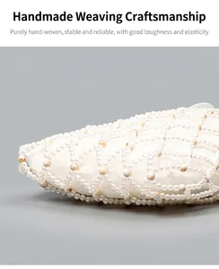 Close-up of hand-woven white pearl beads and delicate silk lining on the handbag