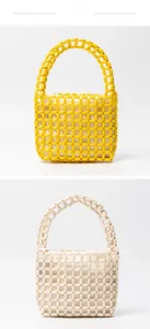 Detail of colorful wooden bead bags in yellow and cream with textured woven patterns